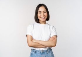 portrait-happy-asian-woman-smiling-posing-confident-cross-arms-chest-standing-against-studio-background.jpg